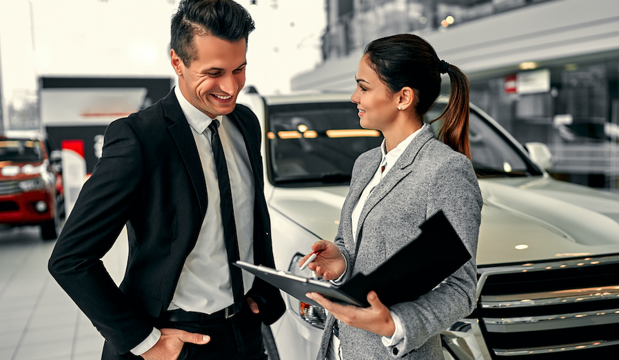 Man and Woman in Auto Dealership