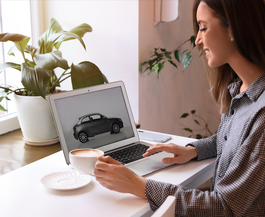 Woman Viewing a Car on Her Laptop