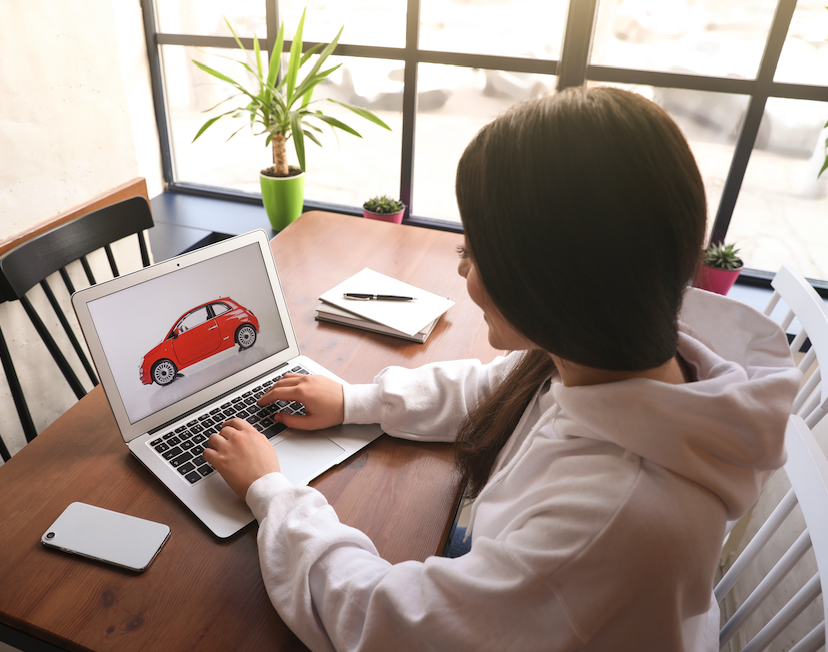 Woman Viewing a Car on Her Laptop